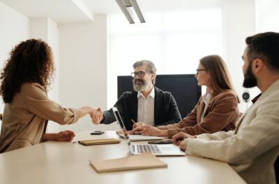 Man shaking hands with new team members