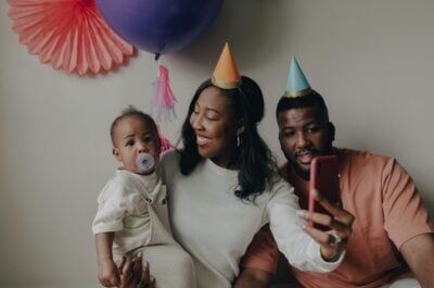 Mom and family in birthday hats posing for photo