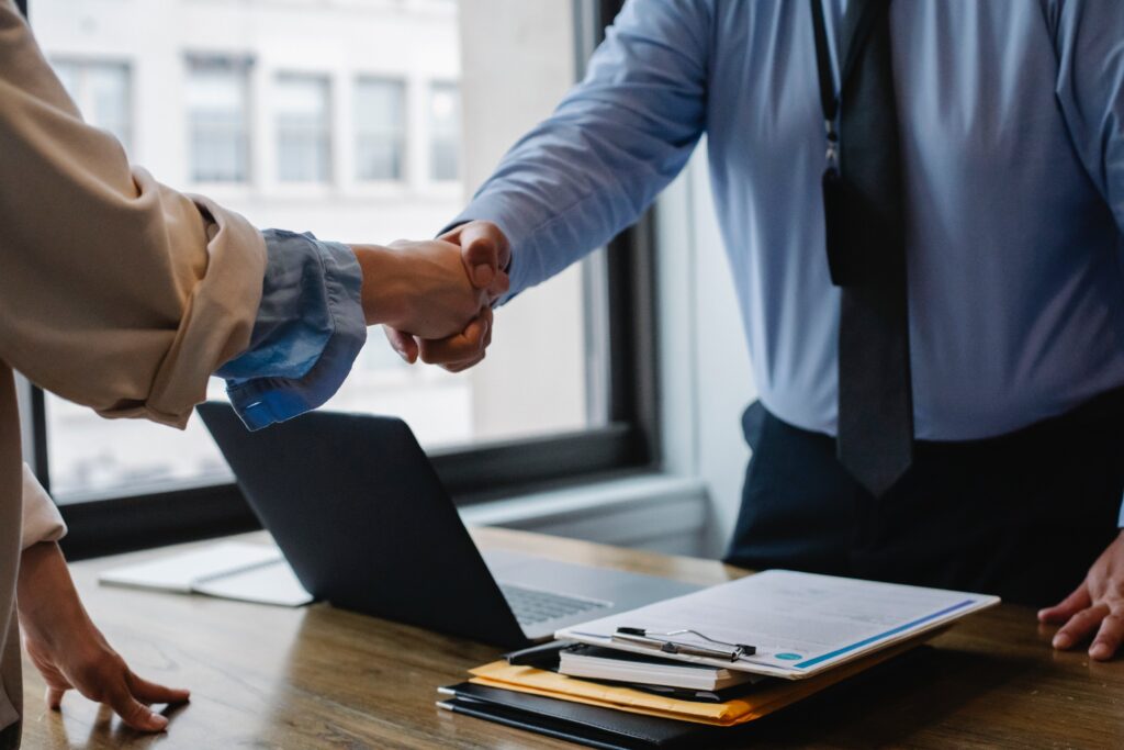 Retiring boss shaking hands with employee