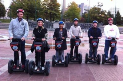 Group of people riding Segways