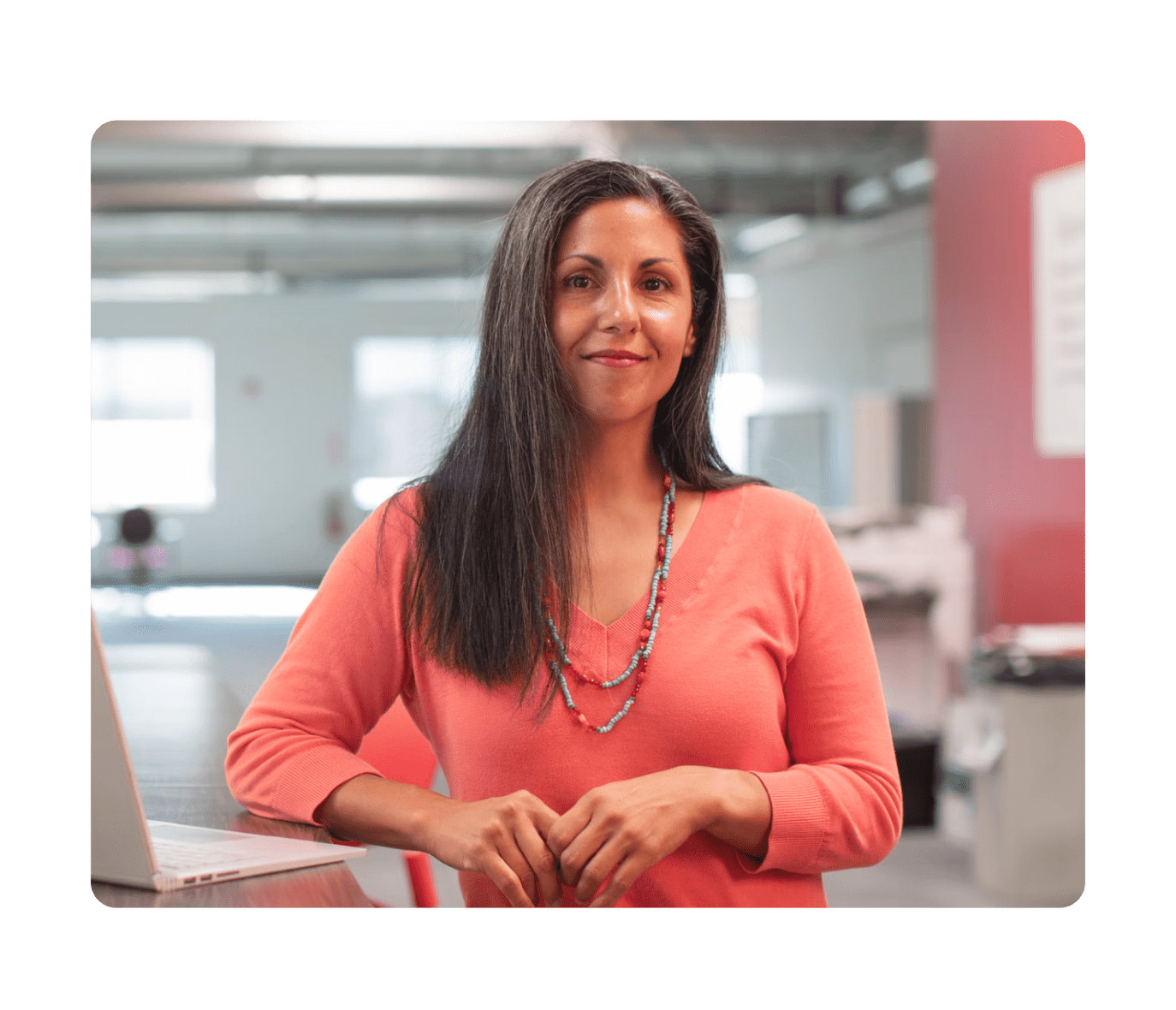 Woman in office looking at laptop